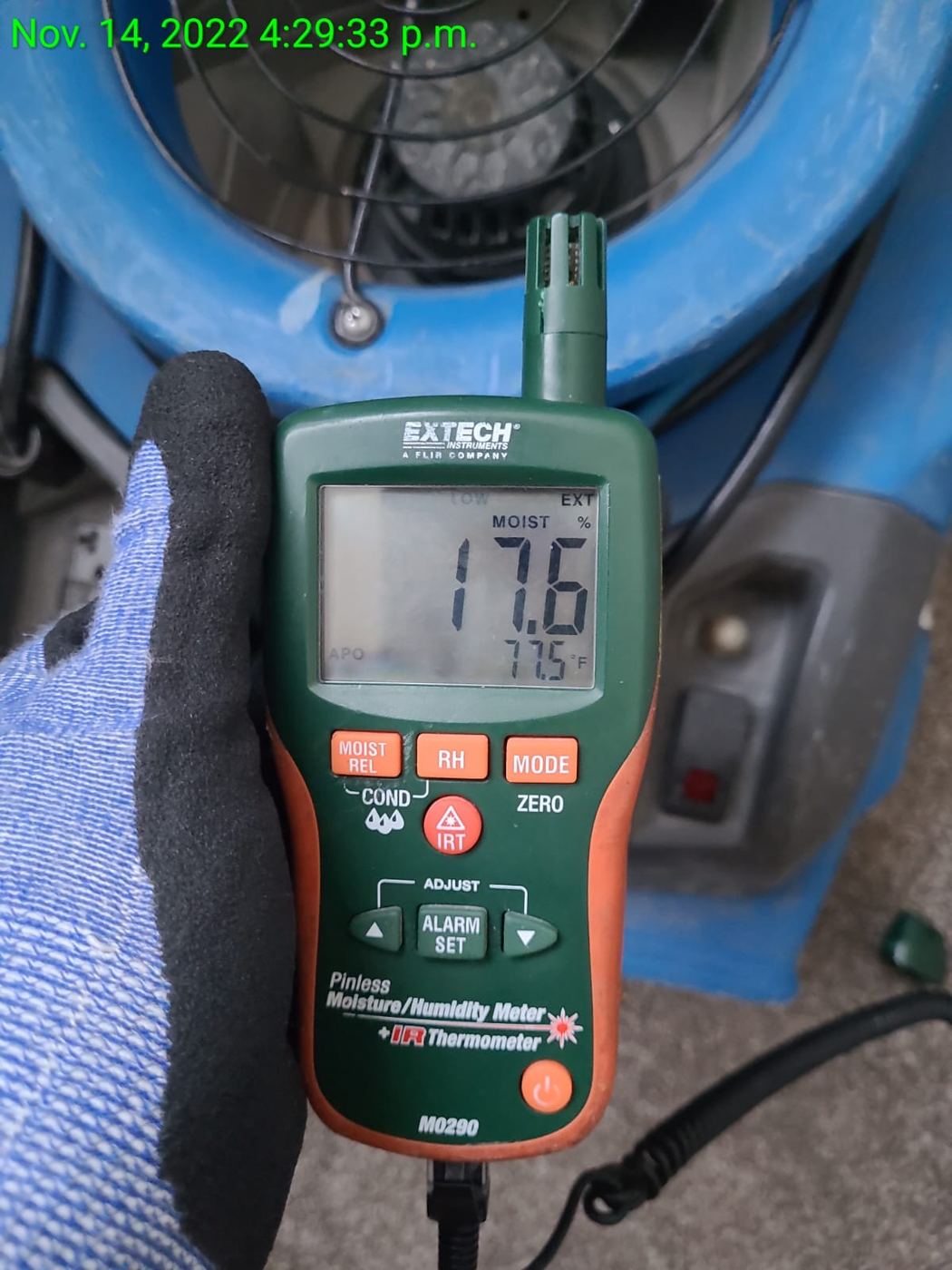 Moisture meter reading taken beside an air mover and recorded as part of a daily drying log
